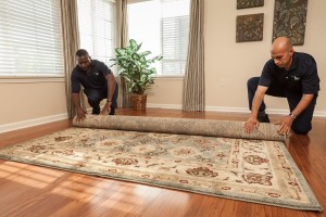 ServiceMaster Technicians Rolling a Rug